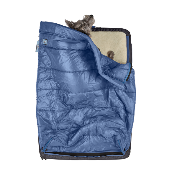 Kashi the dog sleeping comfortably in her light blue colored sleeping bag for dogs and pets, a patented feature of the RuffRest travel dog bed, dog beds for large dogs, best dog beds for small dogs, dog sleeping in bed